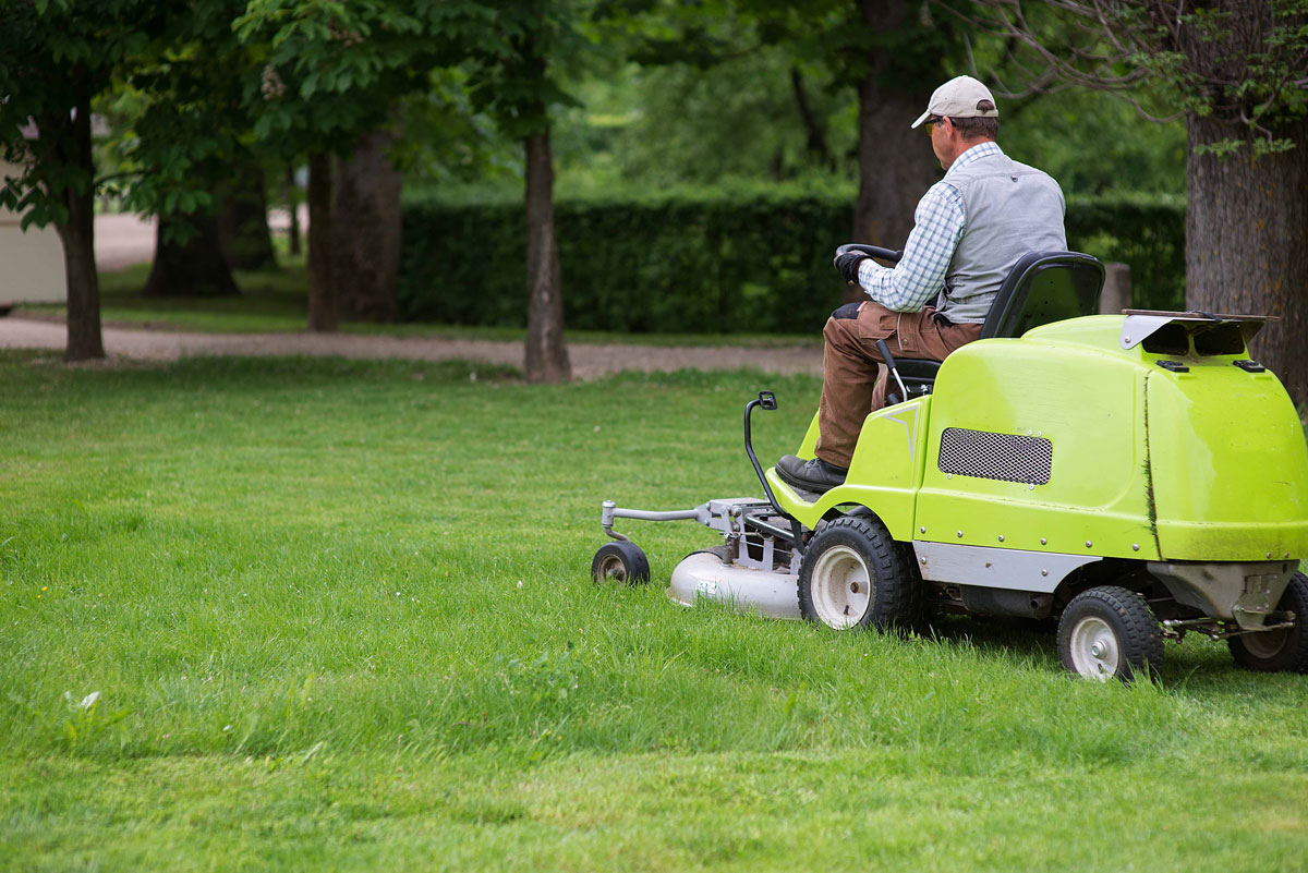 professional-lawn-mower-cuts-the-grass-gardener-in-the-park-on-a-lawn-cutting-tractor_t20_8d2gNj
